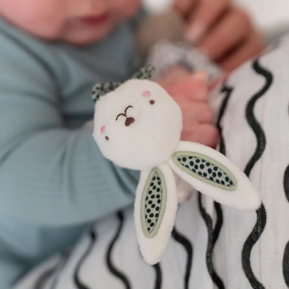 Baby holding a plush bunny toy