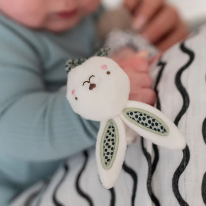 Baby holding a plush bunny toy