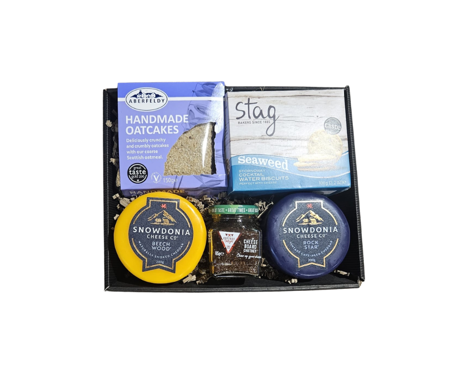 Assorted food items including oatcakes, seaweed, and cheese in a box
