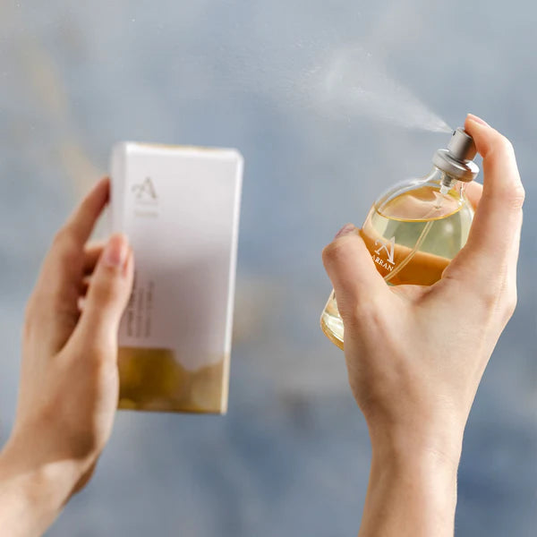 Person holding a perfume bottle and packaging