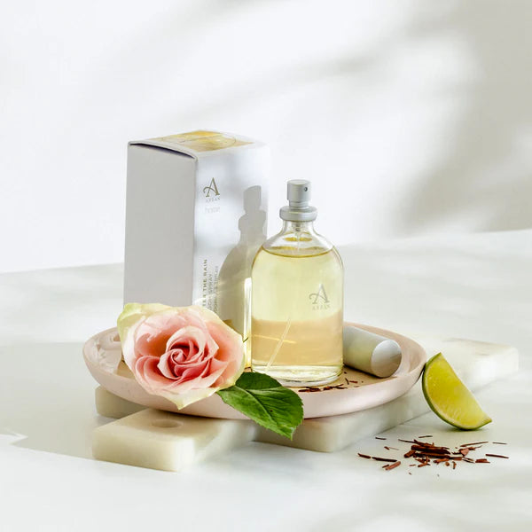Perfume bottle with a rose, lime, and packaging